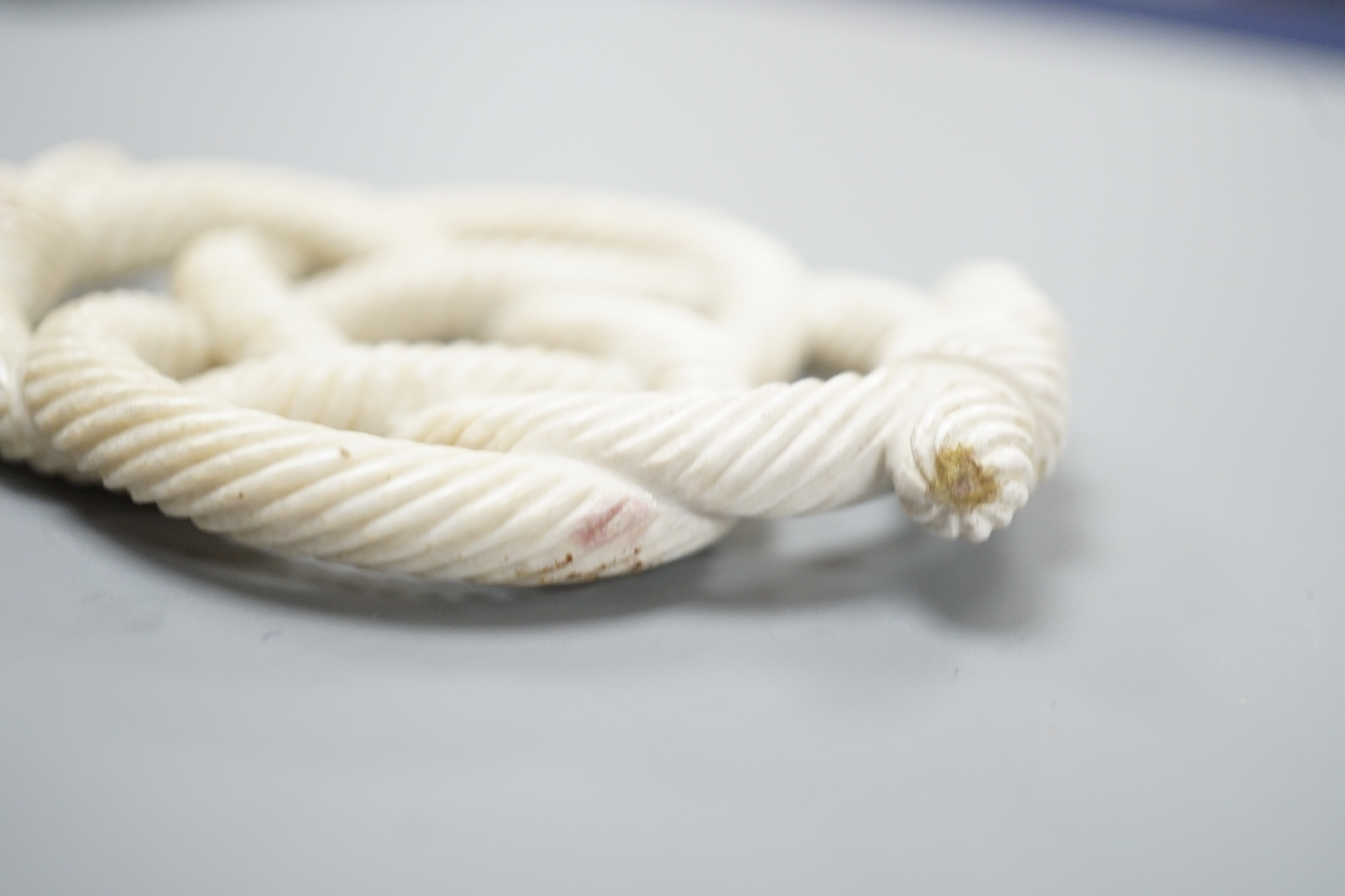 A Chinese hardstone eternal knot carving, 19th century, possibly burnt jade, 8.4cm